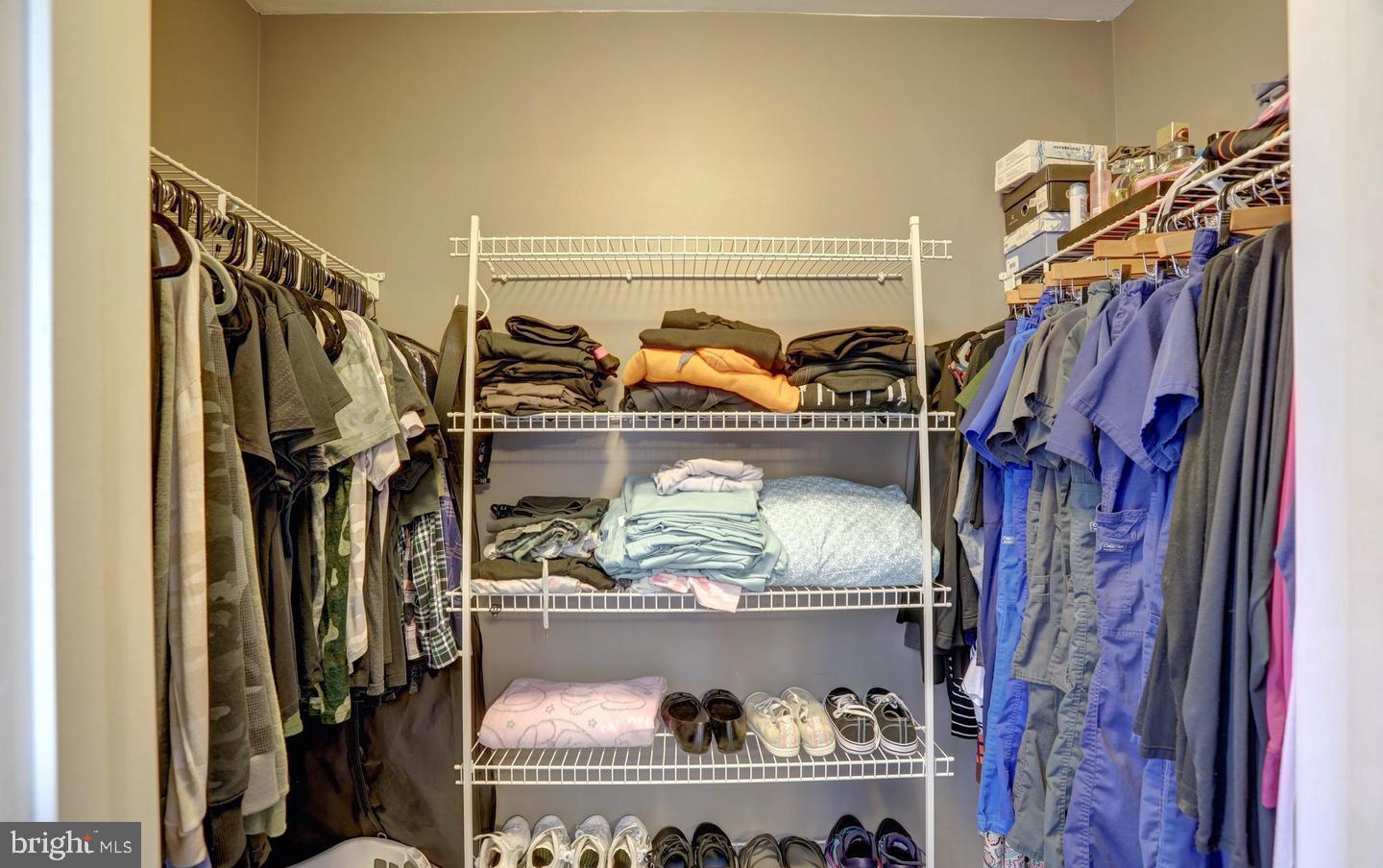102 Cagney Terrace Southeast Leesburg, VA 20175 - Photo 19 of 26 a view of walk in closet with clothes and shoes