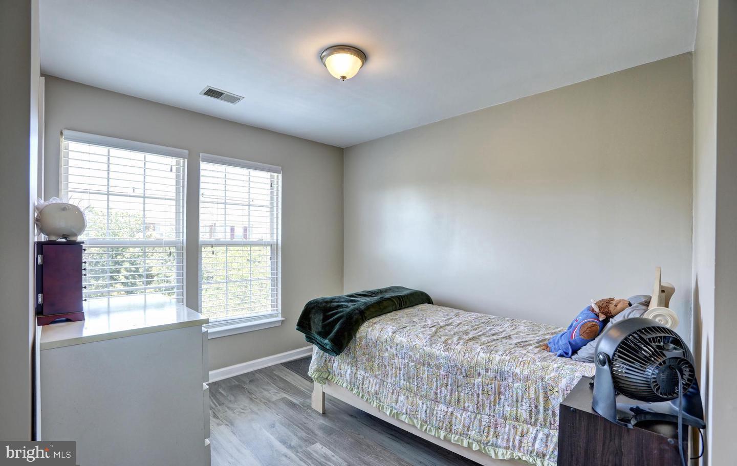 102 Cagney Terrace Southeast Leesburg, VA 20175 - Photo 22 of 26 a bedroom with a bed and a window