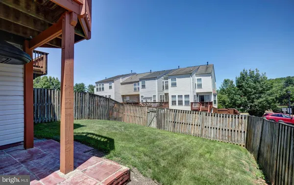 a view of a house with wooden fence