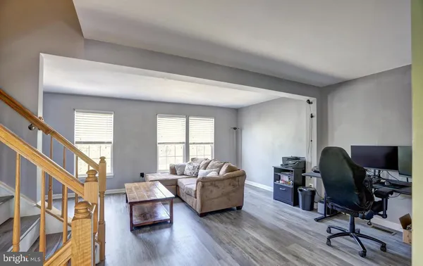 a livingroom with workspace and a window