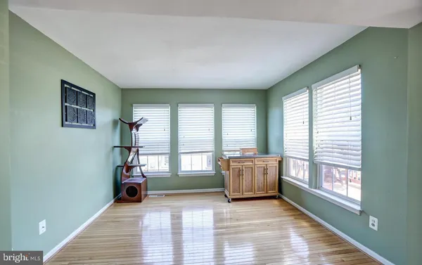 a living room with furniture and large windows