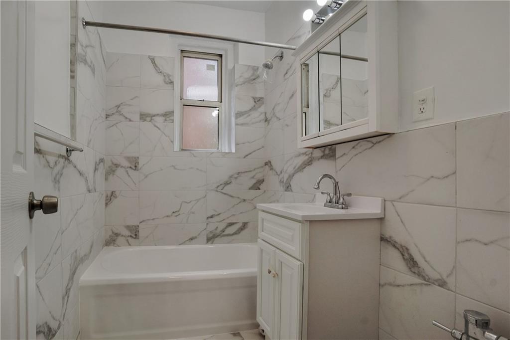 868 East 7th Street, Unit 1A Brooklyn, NY 11230 - Photo 4 of 7 a bathroom with a sink a toilet and bathtub