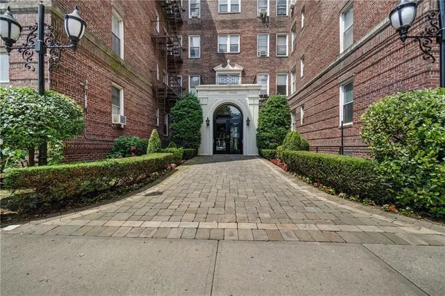 a view of a building with brick walls and plants