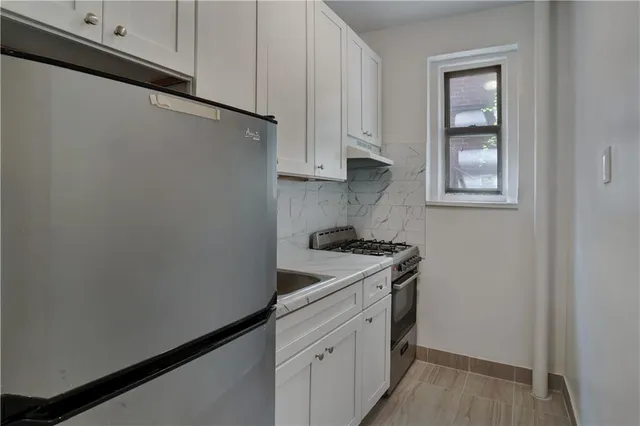 a utility room with sink dryer and washer
