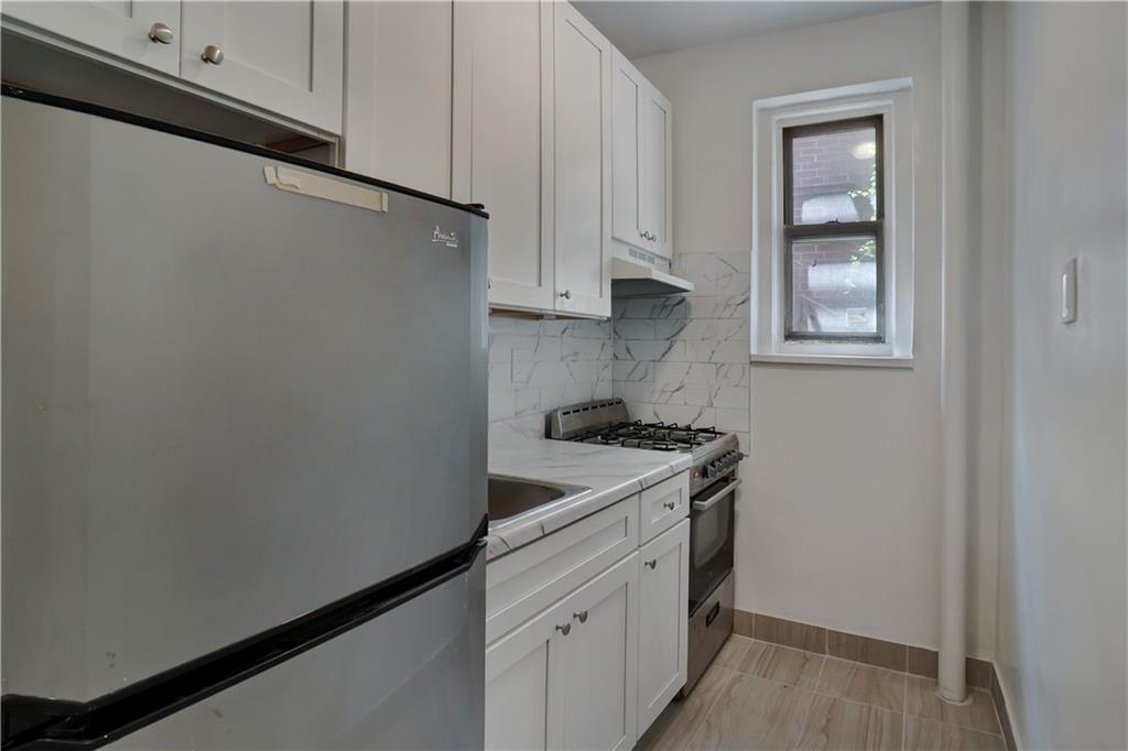 868 East 7th Street, Unit 1A Brooklyn, NY 11230 - Photo 7 of 7 a utility room with sink dryer and washer