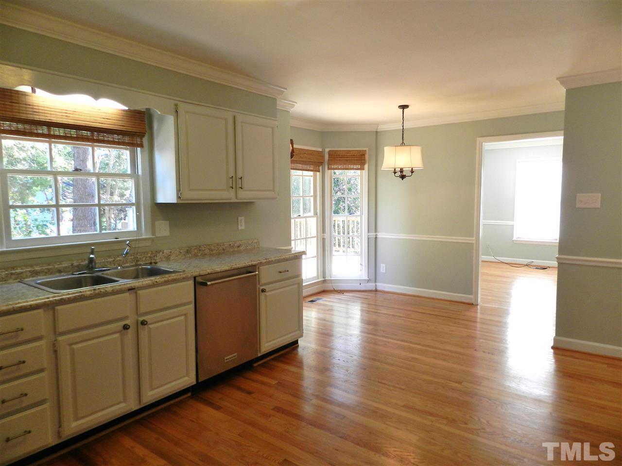 103 Rother Lane Durham, NC 27707 - Photo 11 of 24 a kitchen with stainless steel appliances granite countertop a sink and wooden cabinets