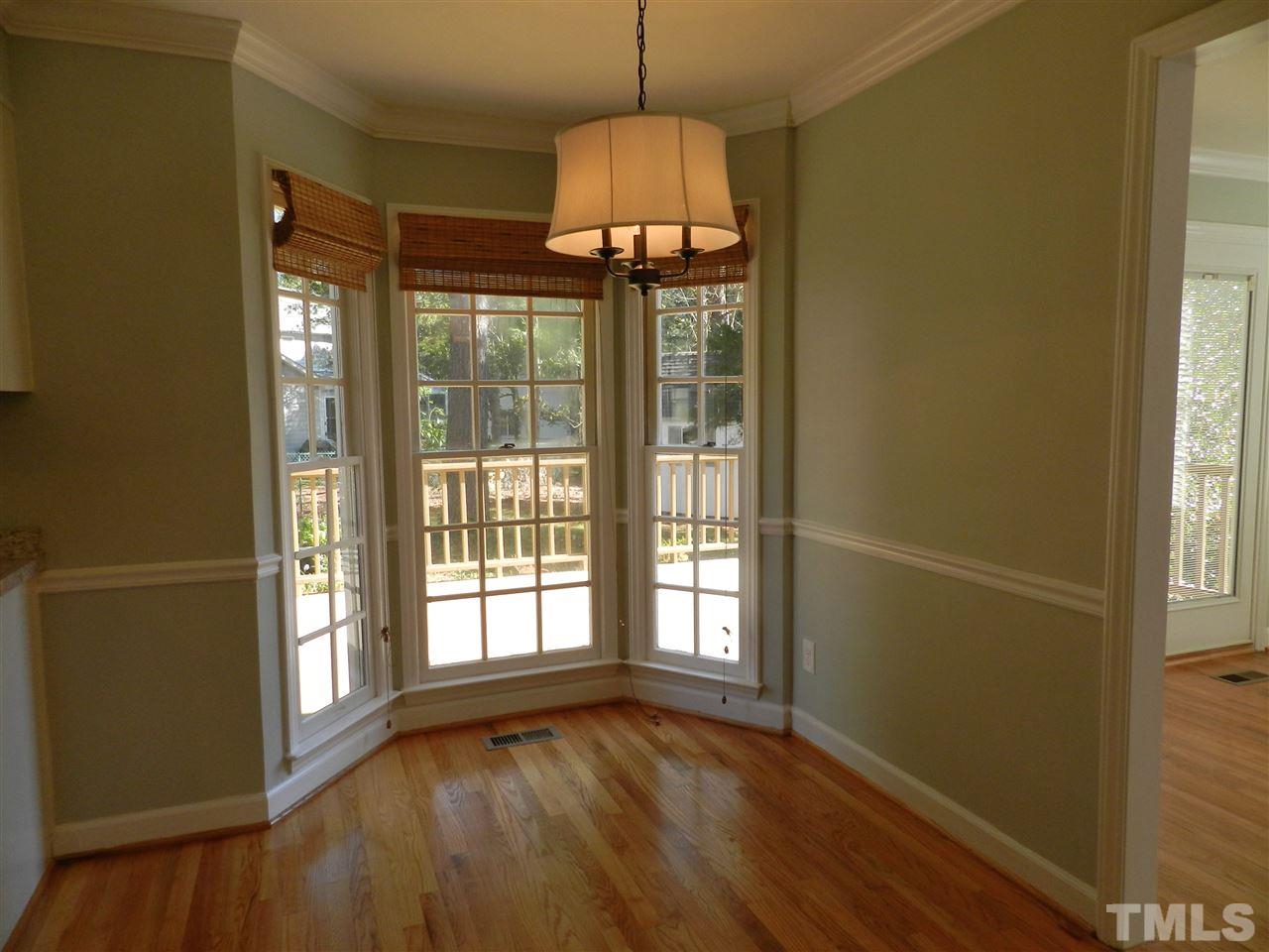 103 Rother Lane Durham, NC 27707 - Photo 12 of 24 a view of an empty room with wooden floor and a window