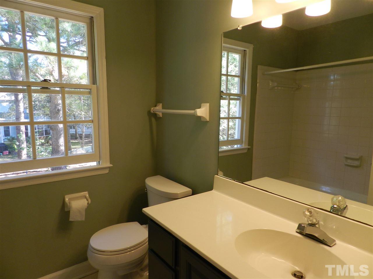 103 Rother Lane Durham, NC 27707 - Photo 20 of 24 a bathroom with a sink toilet and window