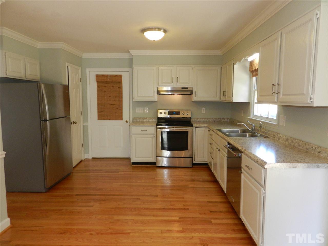 103 Rother Lane Durham, NC 27707 - Photo 7 of 24 a kitchen with stainless steel appliances a refrigerator and a stove top oven