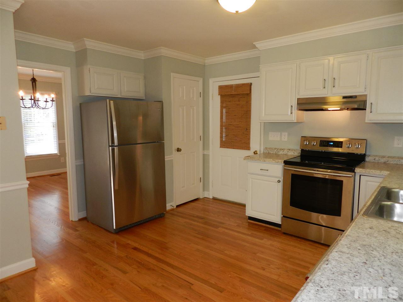 103 Rother Lane Durham, NC 27707 - Photo 8 of 24 a kitchen with a refrigerator stove and wooden floor