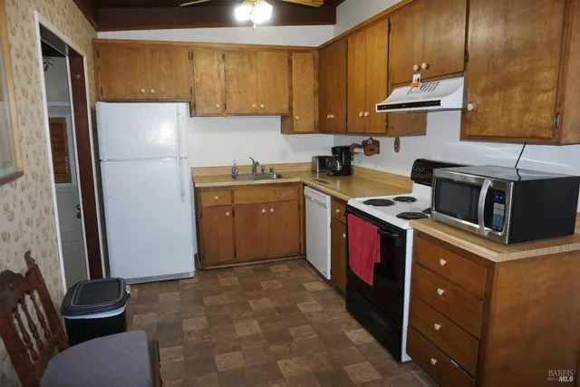 a kitchen with a refrigerator sink and stove