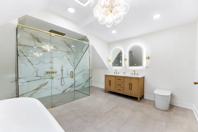 a spacious bathroom with a double vanity sink toilet and a mirror