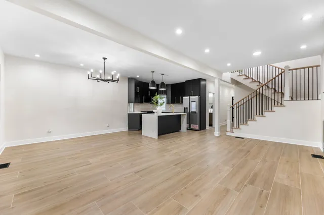 a view of a kitchen with a sink and a refrigerator