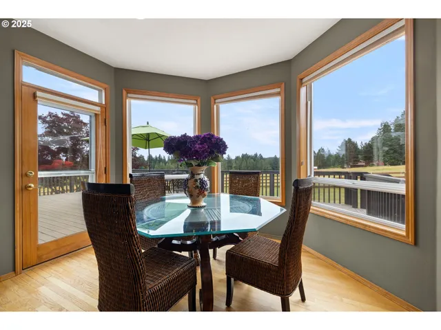 a dining room with furniture window and wooden floor