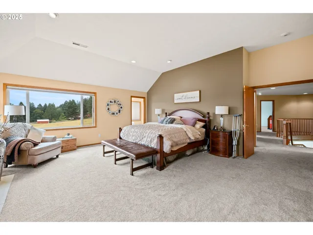 a bedroom with bed and a large window