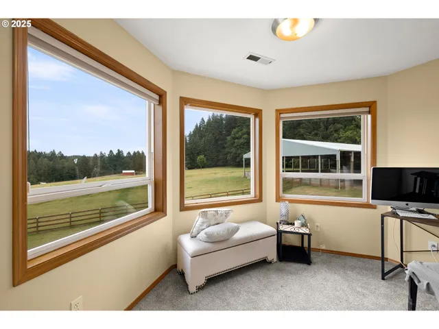 a living room with a large window and a flat screen tv