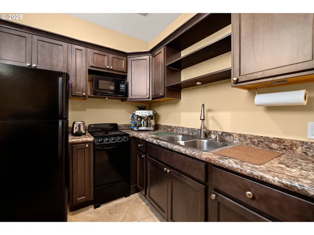a kitchen with granite countertop stainless steel appliances and wooden cabinets