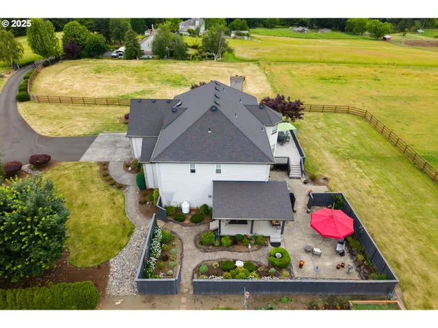 an aerial view of residential houses with outdoor space and swimming pool