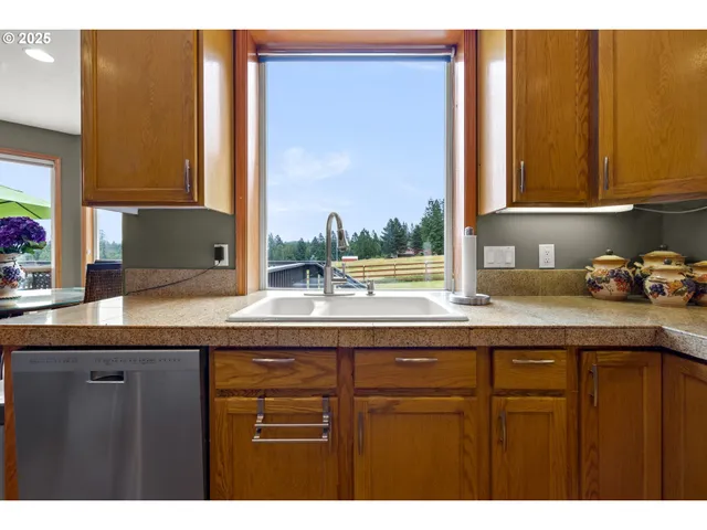 a kitchen with a sink a window and cabinets