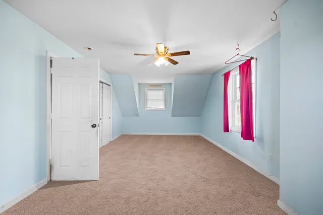 a workspace with a chandelier fan and a window