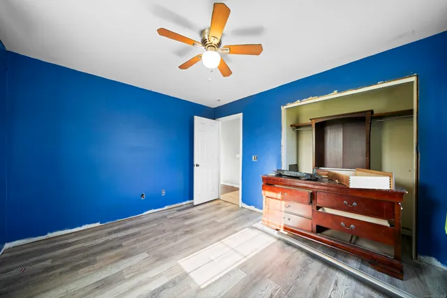 a bed room with a bed and a ceiling fan