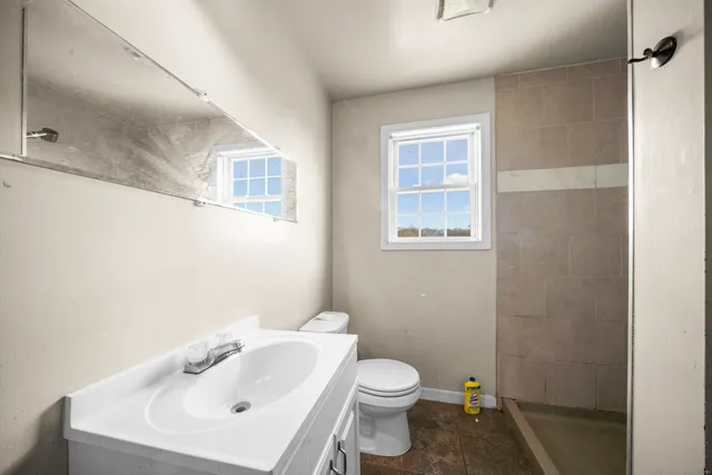 a white toilet sitting next to a bathroom sink