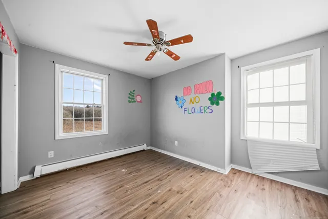 wooden floor in an empty room with a window