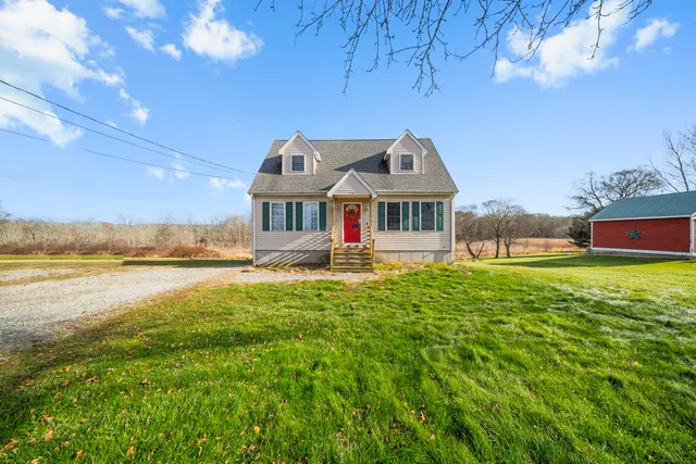 a front view of a house with a yard table and chairs
