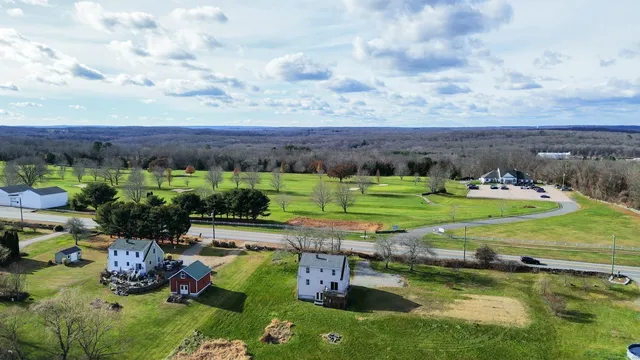 an aerial view of a house with yard