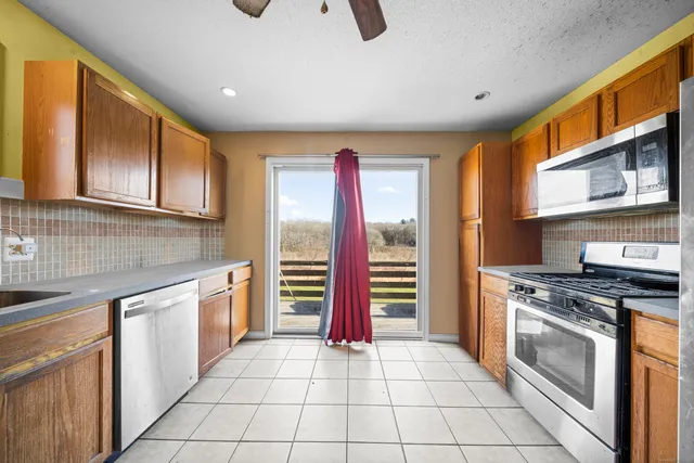 a kitchen with stainless steel appliances granite countertop a stove and a sink
