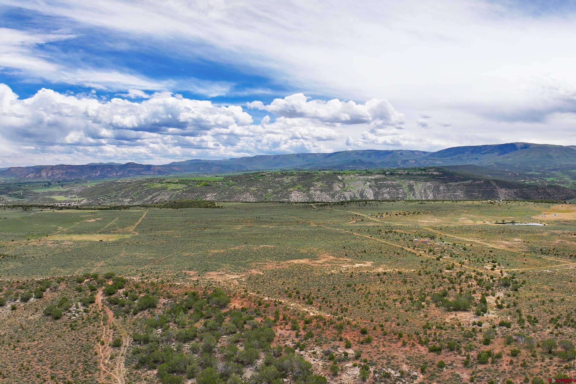 3 53 1/2 Road De Beque, CO 81630 - Photo 4 of 8 a view of a lake with a building in the background