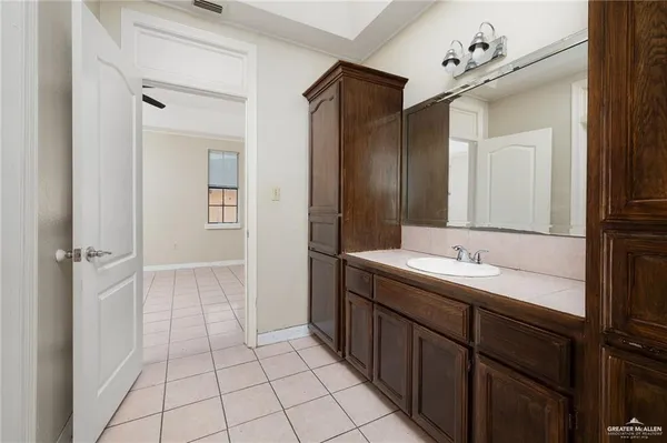 a bathroom with a sink a toilet and mirror