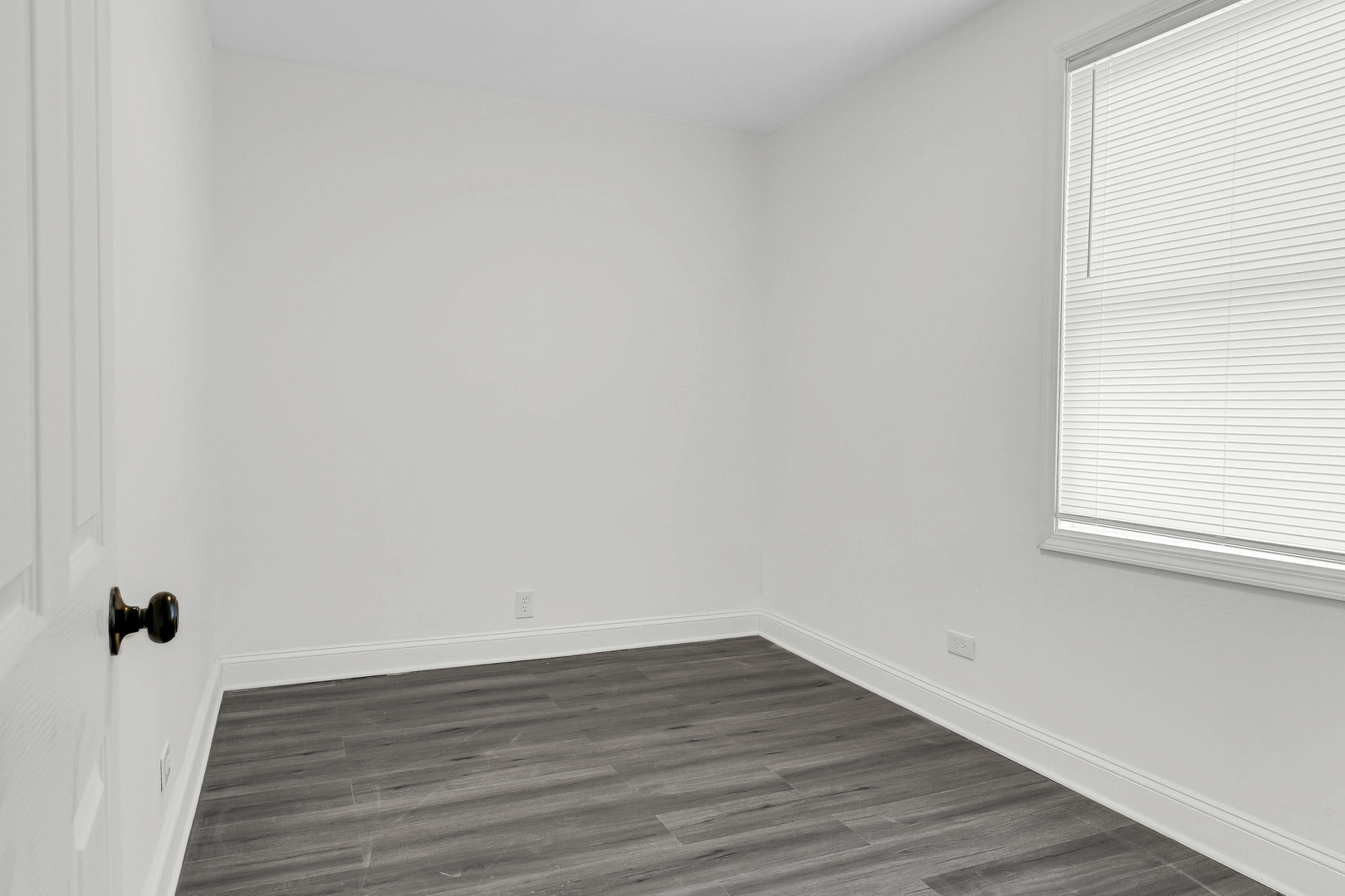 1032 West 103rd Place Chicago, IL 60643 - Photo 13 of 19 a view of an empty room with wooden floor and a window