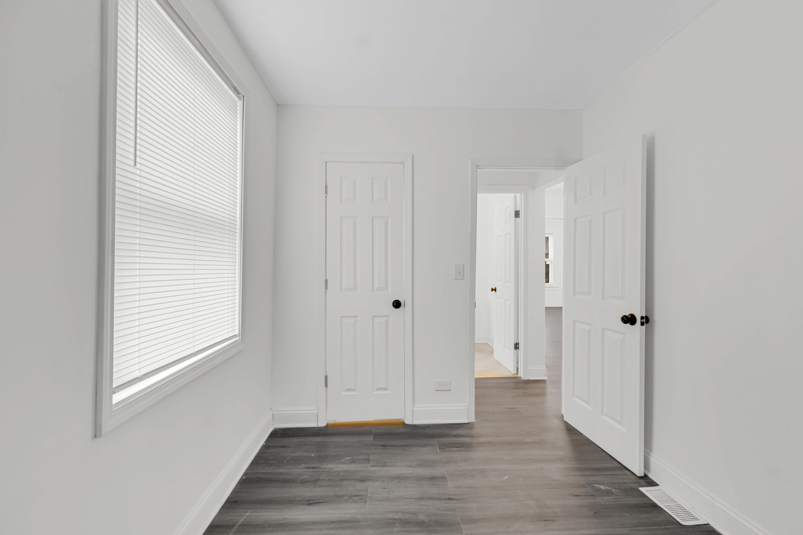 1032 West 103rd Place Chicago, IL 60643 - Photo 14 of 19 a view of an empty room with wooden floor and a window
