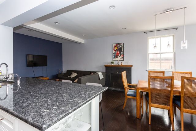 a large kitchen with stainless steel appliances granite countertop a lot of counter space