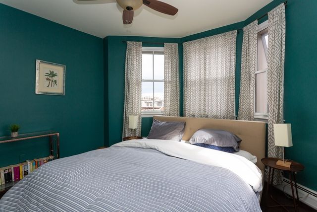 a bedroom with a large bed and a window