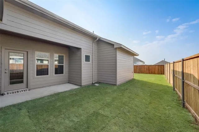 a view of a backyard of the house