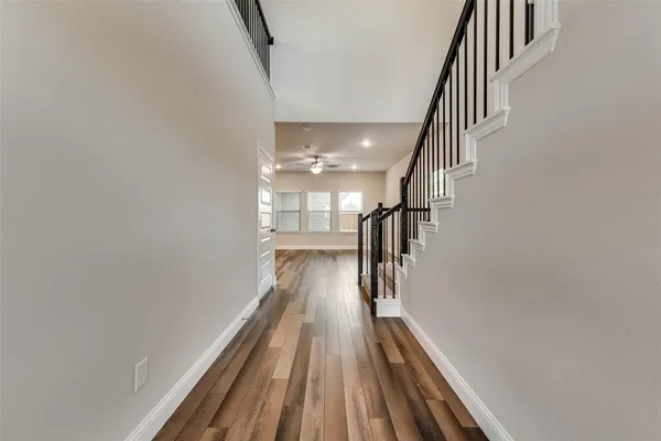 a view of entryway and gallery with wooden floor