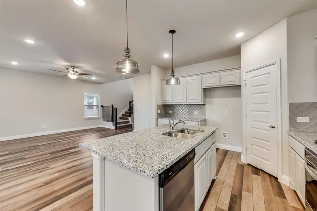 a kitchen with a sink stove and refrigerator