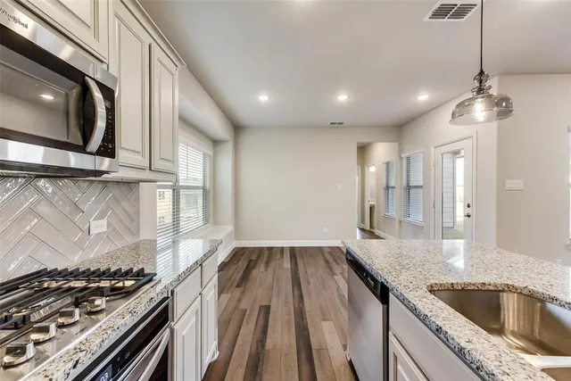 a kitchen with a stove a sink and a refrigerator