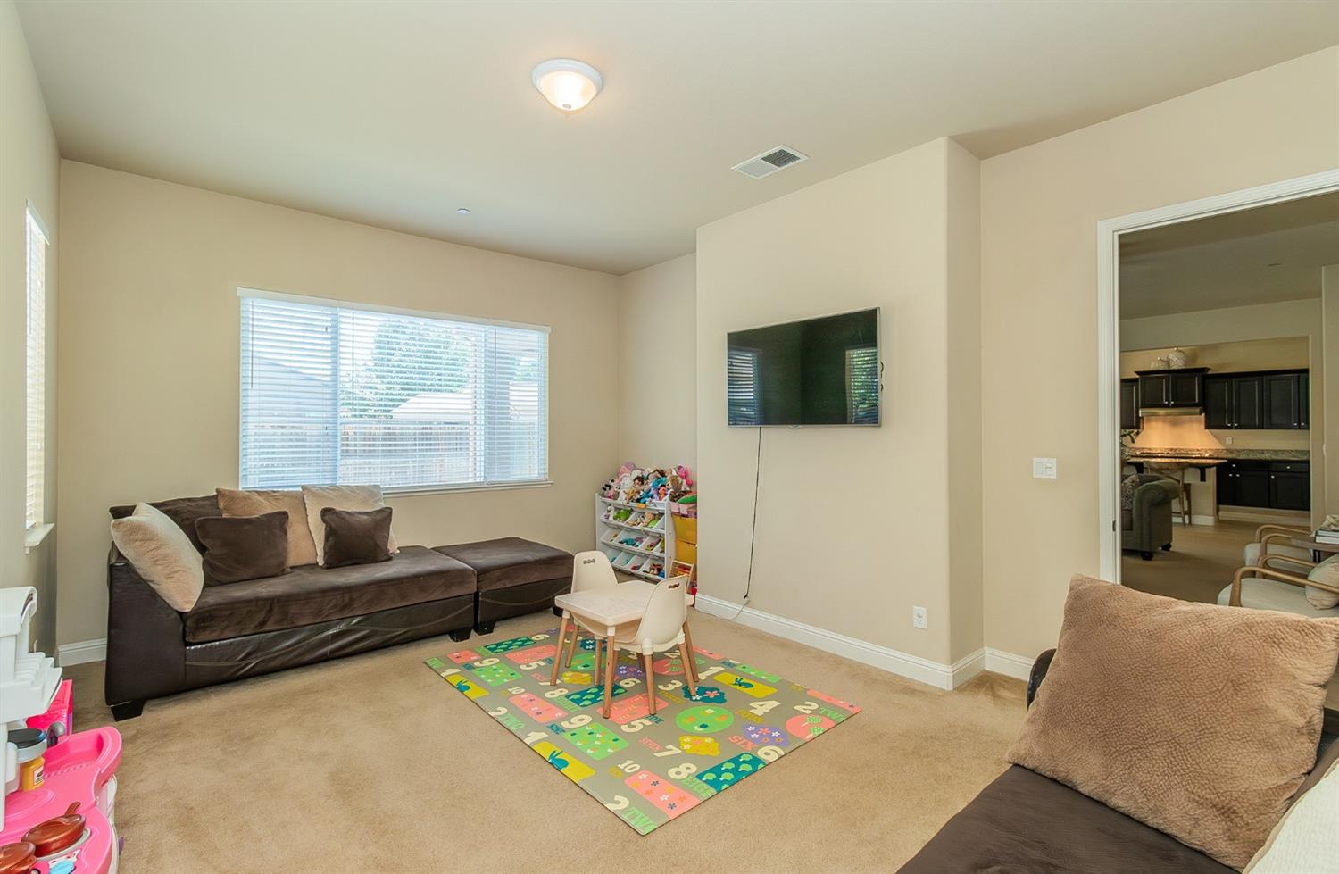 2610 Sample Avenue Clovis, CA 93611 - Photo 12 of 36 a living room with furniture and a flat screen tv