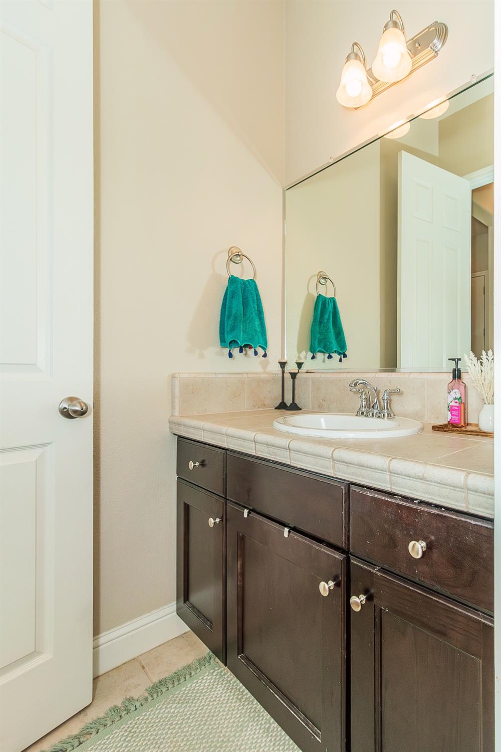 2610 Sample Avenue Clovis, CA 93611 - Photo 16 of 36 a bathroom with a sink and a mirror