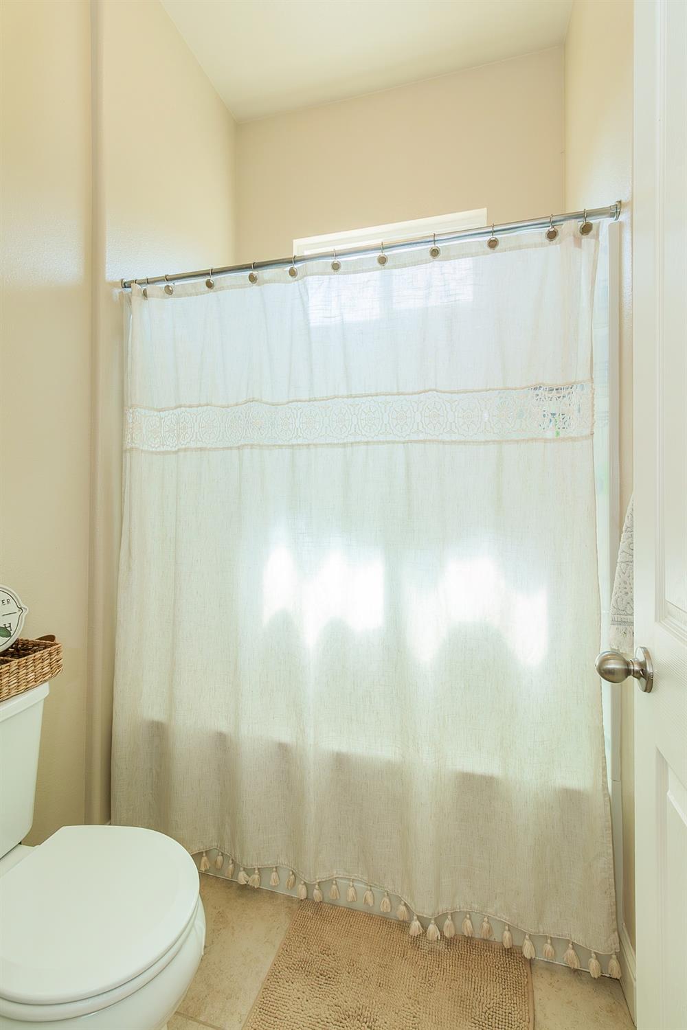 2610 Sample Avenue Clovis, CA 93611 - Photo 17 of 36 a white toilet sitting next to a shower