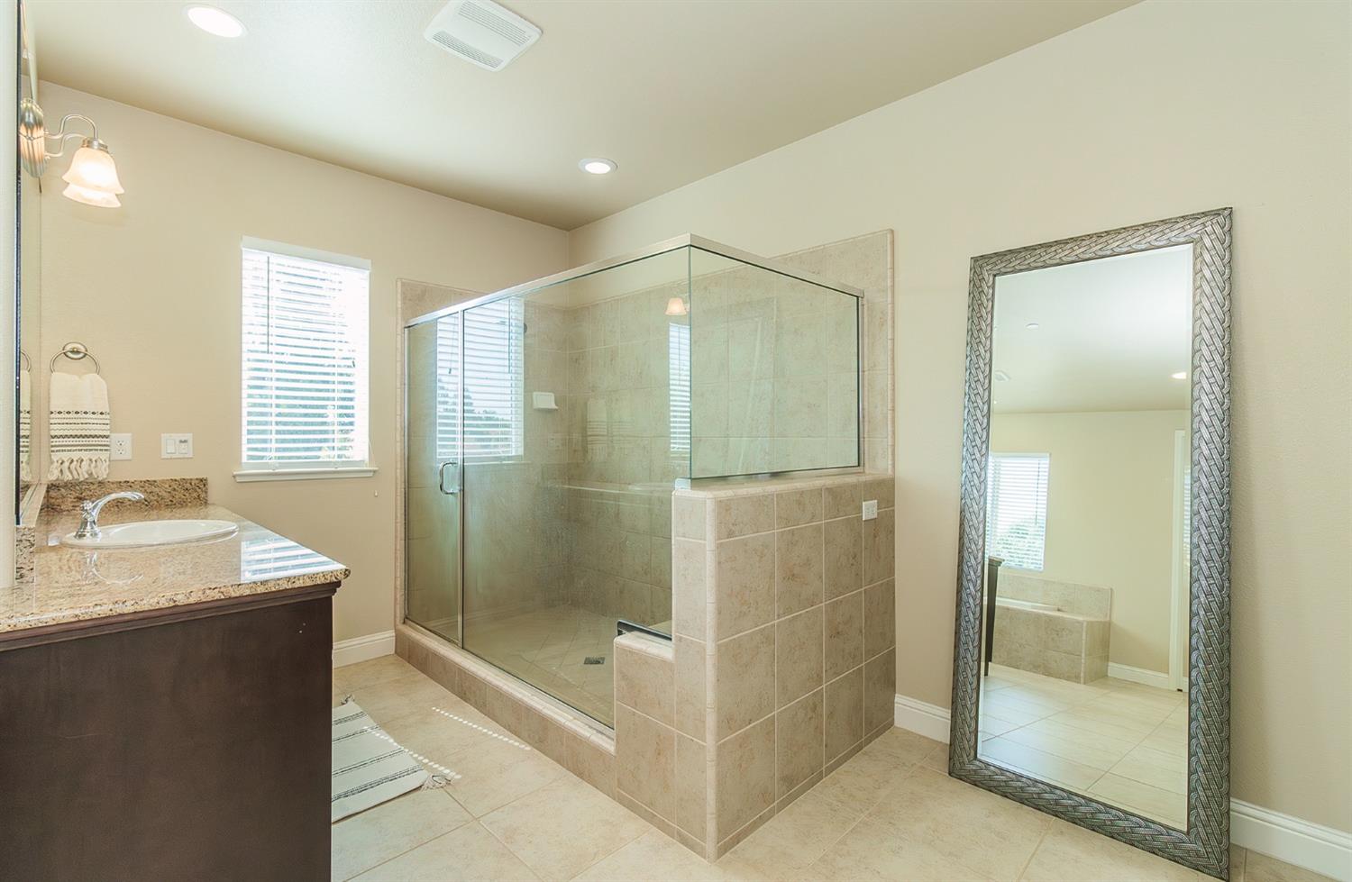 2610 Sample Avenue Clovis, CA 93611 - Photo 26 of 36 a bathroom with a shower and a sink