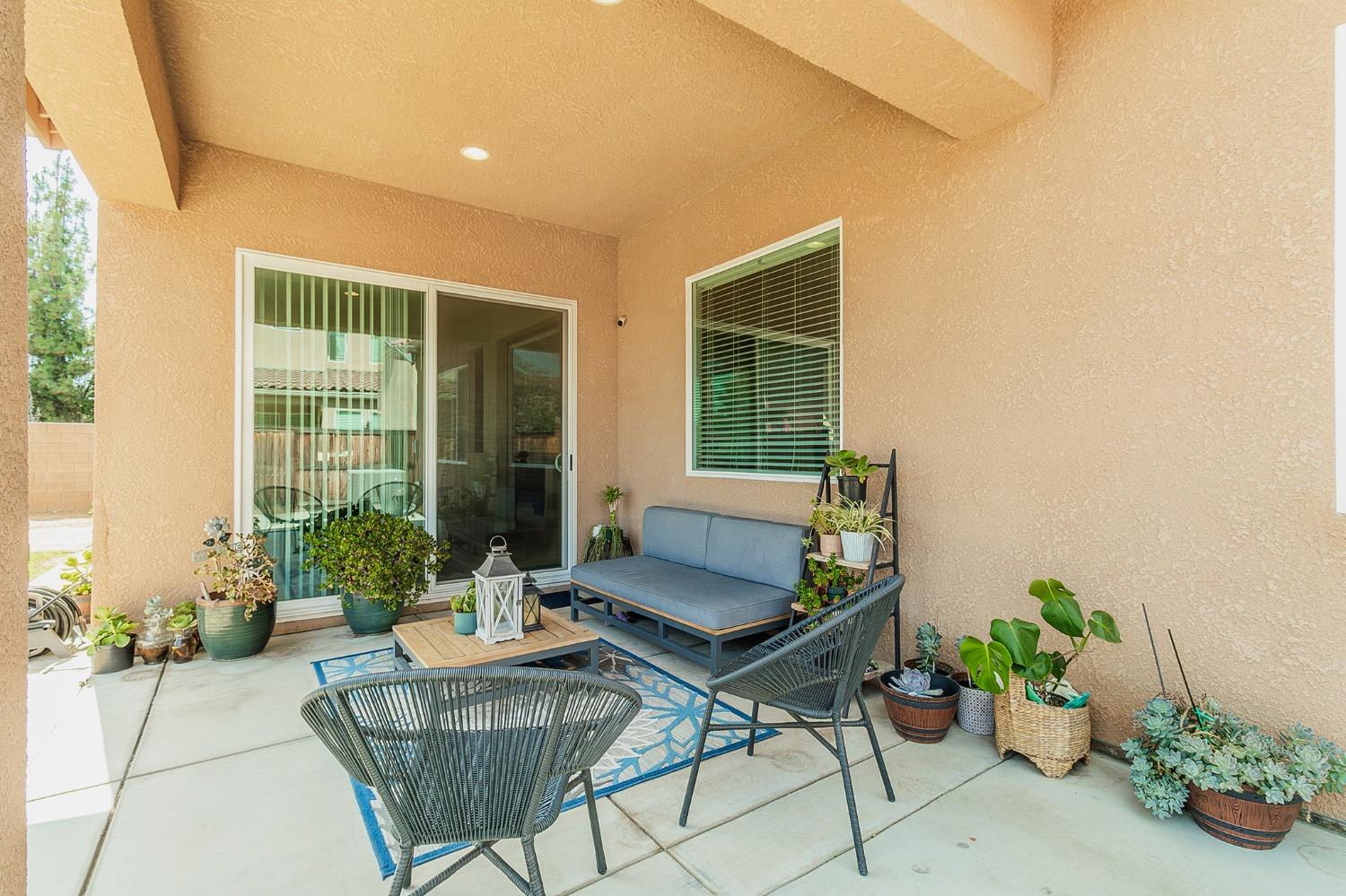 2610 Sample Avenue Clovis, CA 93611 - Photo 32 of 36 a living room with furniture and a potted plant