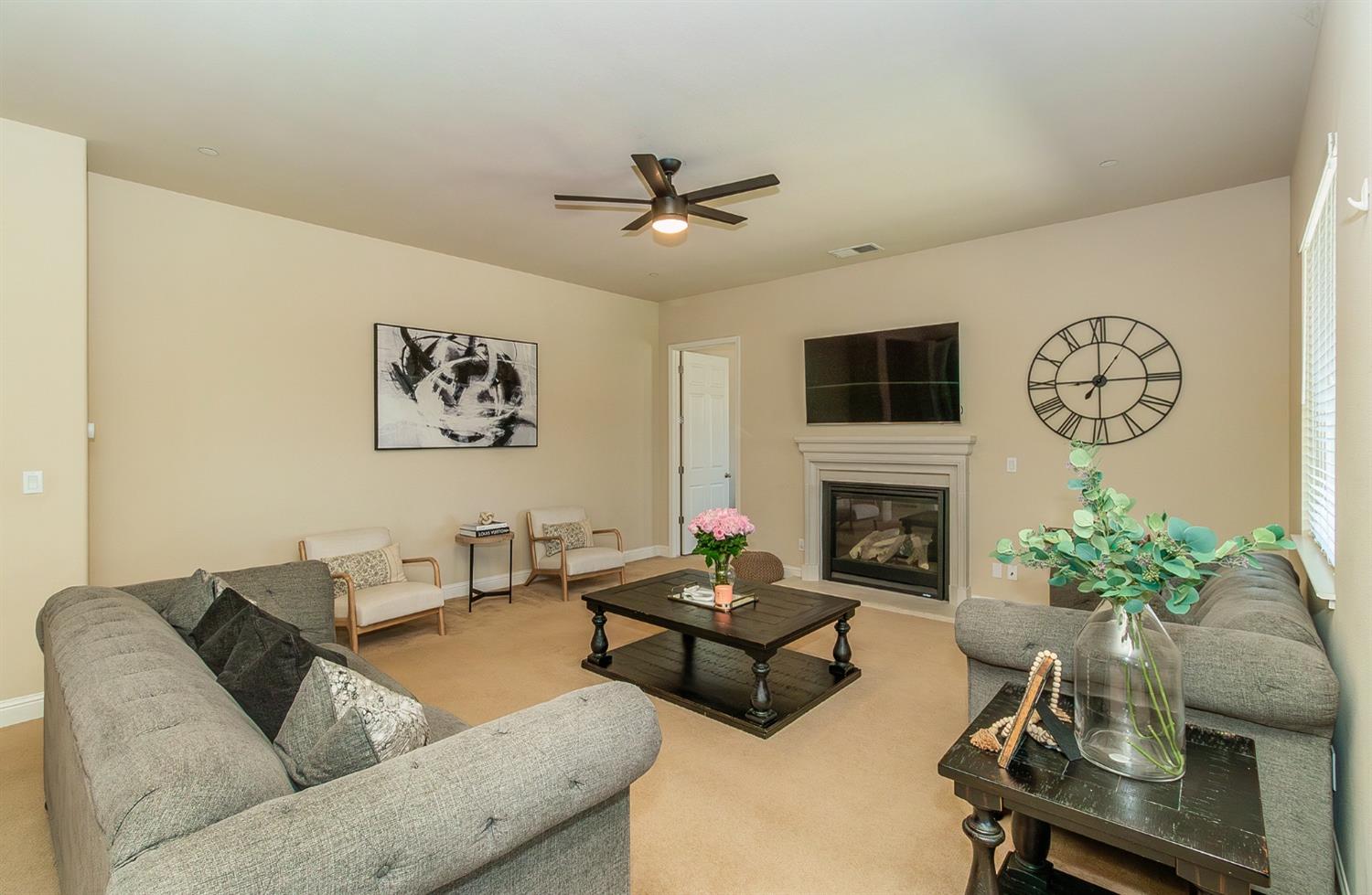2610 Sample Avenue Clovis, CA 93611 - Photo 7 of 36 a living room with furniture a fireplace and a potted plant