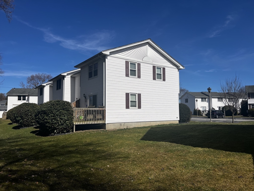 55 Empire Street, Unit 52 Chicopee, MA 01013 - Photo 3 of 18 a front view of a house with a garden