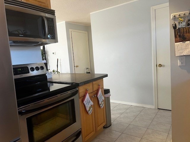 55 Empire Street, Unit 52 Chicopee, MA 01013 - Photo 9 of 18 a kitchen with a stove and a microwave