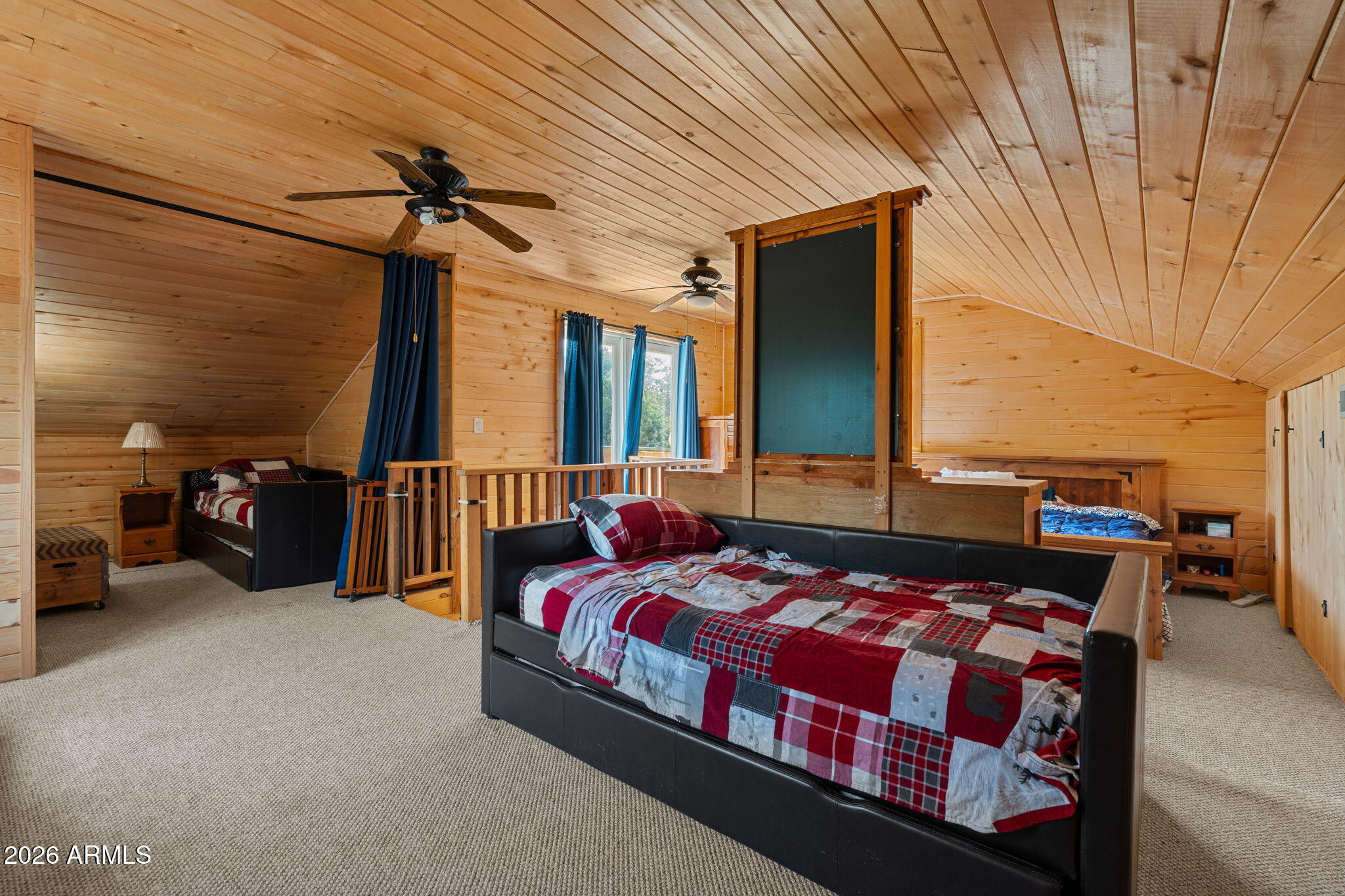 2095 Ranger Road Overgaard, AZ 85933 - Photo 12 of 25 a bedroom with a bed and a chandelier