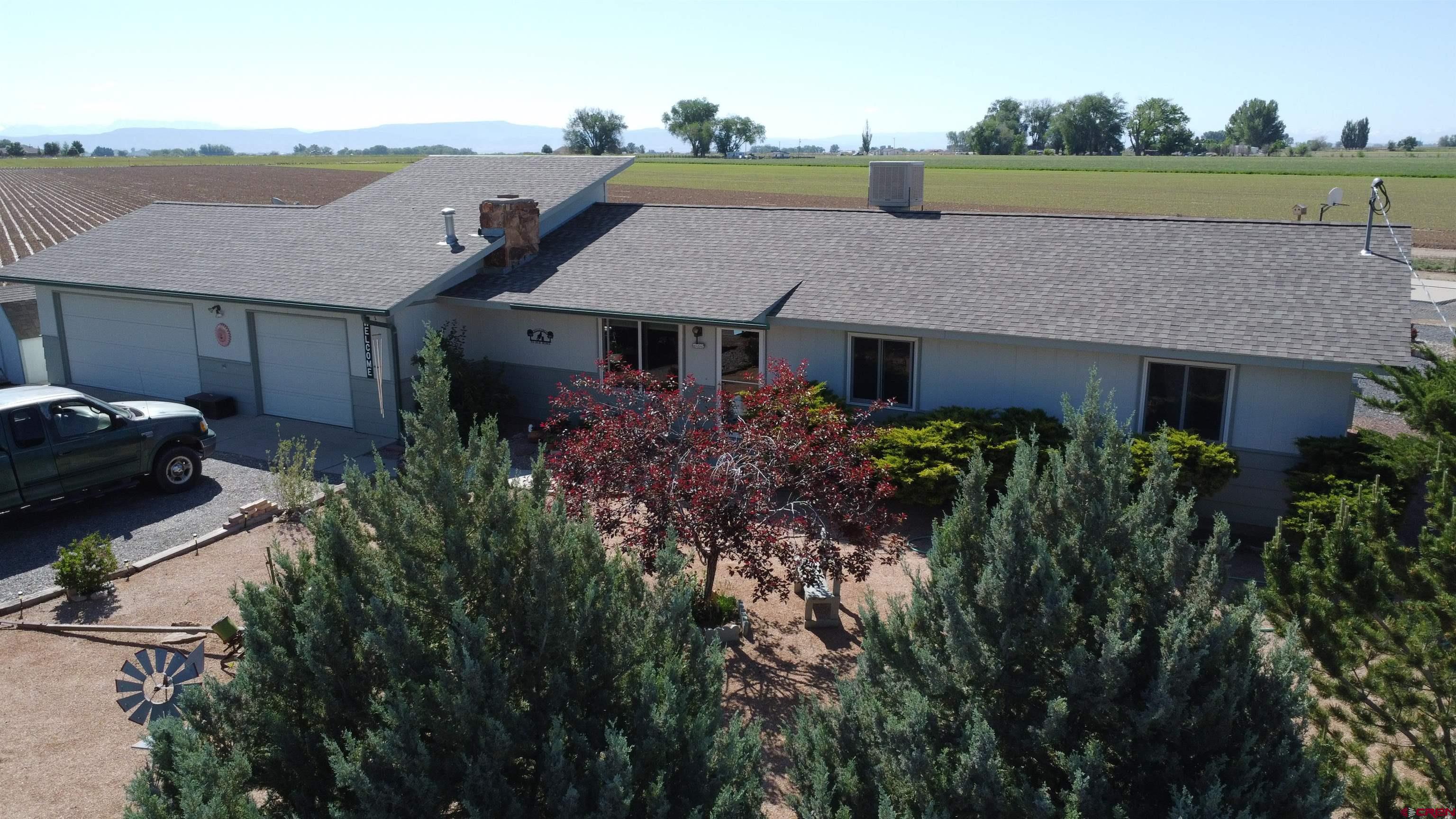13762 F Road Delta, CO 81416 - Photo 3 of 34 an aerial view of a house with a garden and lake view